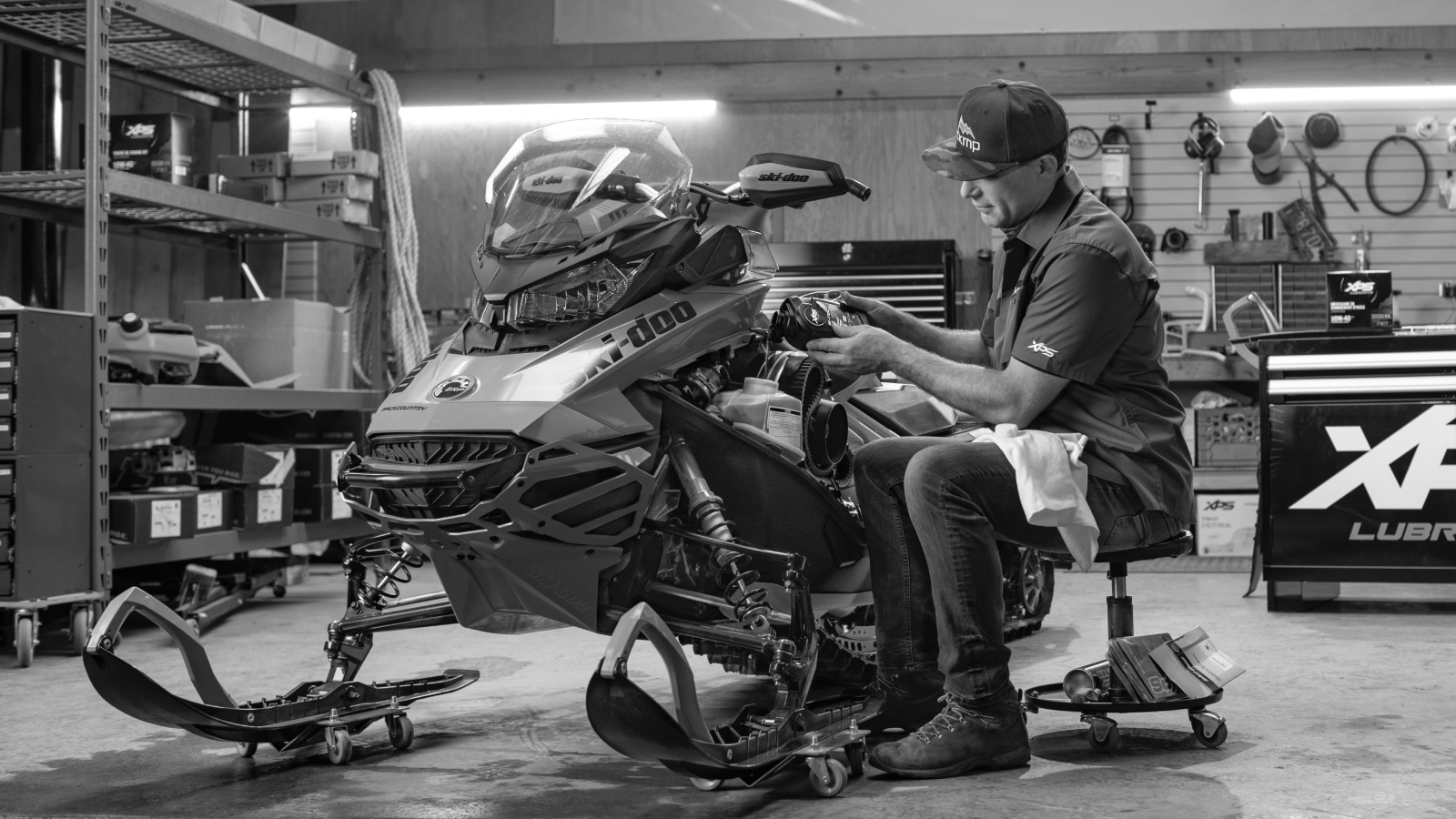 Rider performing maintenance on his Ski-Doo snowmobile